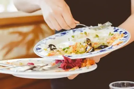 Waiter clearing plates